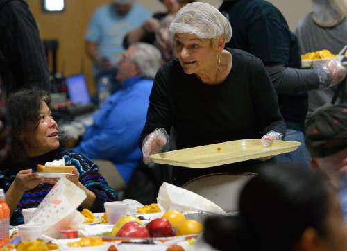 Leah Hogsten  |  The Salt Lake Tribune
Thanksgiving day volunteer Dee Orr from Hartville, Wyo., puts a smile on diners faces while handing out pumpkin pie during the midday Thanksgiving meal for low-income and homeless families. The Salt Lake City Mission provided Thanksgiving meals at the Christian Life Center, Thursday, November 27, 2014 in Salt Lake City.