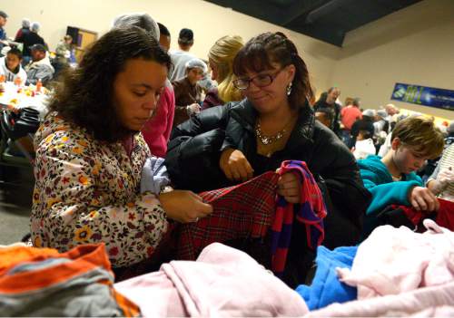 Leah Hogsten  |  The Salt Lake Tribune
l-r Jessica Aponte and Toni Webb check clothing sizes while looking for clothes for themselves and their daughters after their midday Thanksgiving dinner. The Salt Lake City Mission provided Thanksgiving meals at the Christian Life Center, Thursday, November 27, 2014 in Salt Lake City.