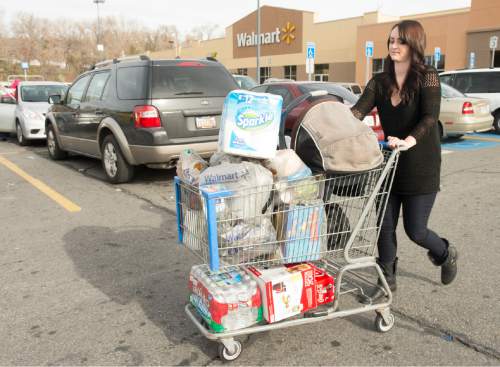 Rick Egan  |  The Salt Lake Tribune

Abbie Carlisle wheels her shopping cart out to her car, on Black Friday, November 28, 2014