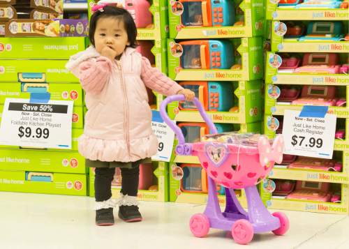 Rick Egan  |  The Salt Lake Tribune

17-month-old Anna Kim pushes a toy shopping cart as she shops with her parents in the Toys R Us in Sugar House after the 4:50 p.m. opening, Thursday, November 27, 2014.