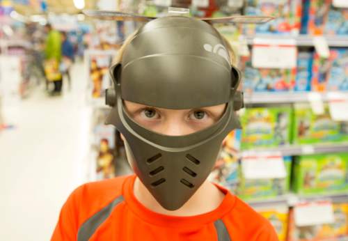 Rick Egan  |  The Salt Lake Tribune

James Fawcett, 7, wears a Stars Wars Rebels Inquisitor mask  while he shops at Toys R Us in Sugar House after the 4:50 p.m. opening, Thursday, November 27, 2014.