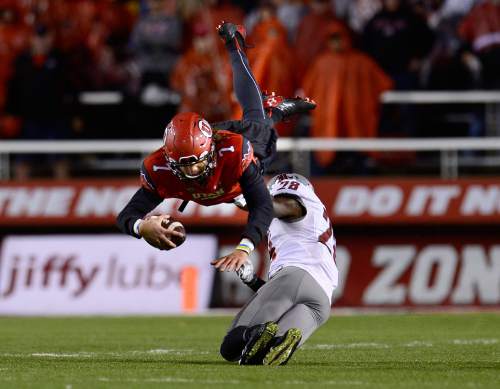 Scott Sommerdorf   |  The Salt Lake Tribune
QB Travis Wilson dove for this first down on a fourth-and 1 play in the fourth quarter, but later would come up empty on fourth down to end the game. Utah lost 28-27 to Washington State, Saturday, September 27, 2014.