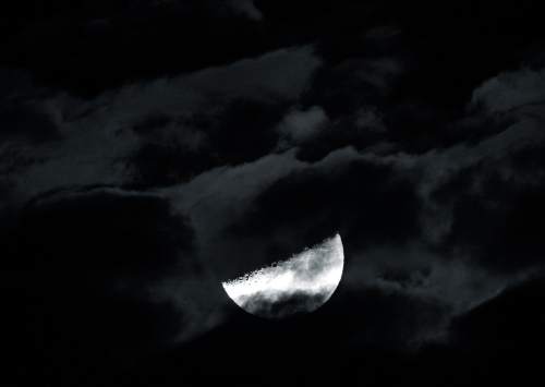 Scott Sommerdorf   |  The Salt Lake Tribune
Broken clouds over Salt Lake City late, Friday, November 28, 2014, gave this half moon an eerie look.