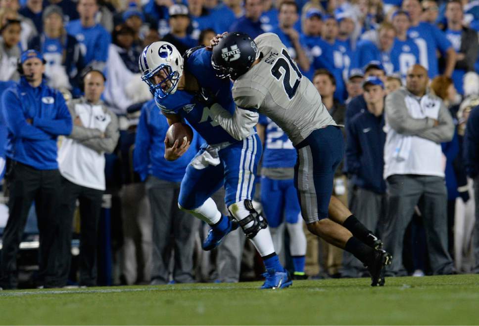 Scott Sommerdorf  |  The Salt Lake Tribune
BYU QB Taysom Hill was injured and left the game after this tackle by Utah State Aggies safety Brian Suite (21) late in the second quarter. Utah State led BYU 28-14 at the half in Provo, Friday, October 1, 2014.