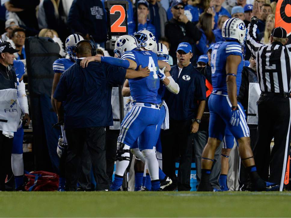 Scott Sommerdorf  |  The Salt Lake Tribune
BYU QB Taysom Hill was helped off the field after he was injured after a tackle by Utah State Aggies safety Brian Suite (21) late in the second quarter. Utah State led BYU 28-14 at the half in Provo, Friday, October 1, 2014.
