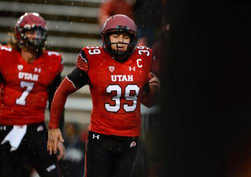 Scott Sommerdorf   |  The Salt Lake Tribune
Kicker Andy Phillips, and QB Travis Wilson, left, warm up in a steady rain prior to facing off against Washington State, Saturday, September 27, 2014.