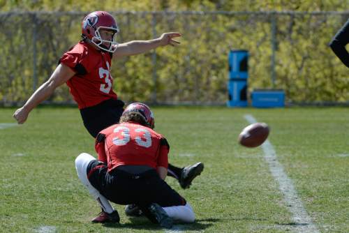 Franciso Kjolseth  |  The Salt Lake Tribune
Quarterback Andy Phillips lines it up with the help of fellow kicker Tom Hackett as the University of Utah football team gets ready for the season during Spring practice at the Spence Eccles Football Facility on Thursday, April 17, 2014.