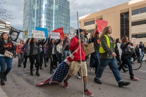 Trent Nelson  |  The Salt Lake Tribune
Protesters march down State Street as more than 200 people turned out for a rally to protest police brutality in Salt Lake City, Saturday November 29, 2014.