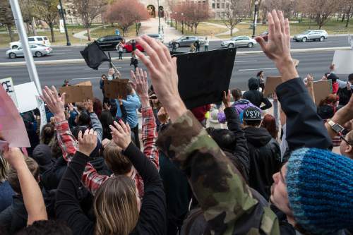 Trent Nelson  |  The Salt Lake Tribune
Protesters hold their hands over their heads in front of the Matheson Courthouse as more than 200 people turned out for a rally to protest police brutality in Salt Lake City, Saturday November 29, 2014.