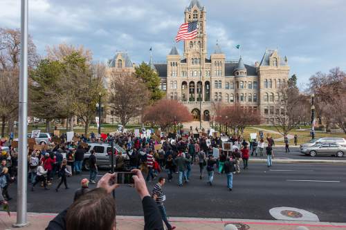 Trent Nelson  |  The Salt Lake Tribune
Protesters march, blocking traffic on State Street as more than 200 people turned out for a rally to protest police brutality in Salt Lake City, Saturday November 29, 2014.