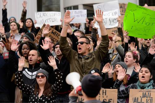 Trent Nelson  |  The Salt Lake Tribune
Protesters hold their hands over their heads on front of the Matheson Courthouse as more than 200 people turned out for a rally to protest police brutality in Salt Lake City, Saturday November 29, 2014.