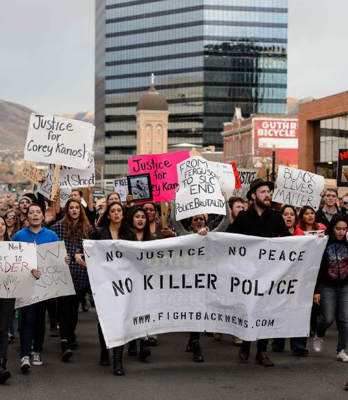 Trent Nelson  |  The Salt Lake Tribune
Protesters march down 200 South, halting traffic, as more than 200 people turned out for a rally to protest police brutality in Salt Lake City, Saturday November 29, 2014.