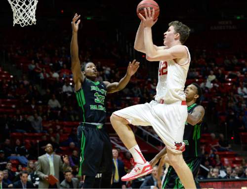 Utah forward Jakob Poeltl (42) drives to the hoop against North Dakota forward Josiah Coleman (35) during the first half on an NCAA college basketball game, Friday, Nov. 28, 2014 in Salt Lake City. (AP Photo/The Salt Lake Tribune, Scott Sommerdorf)  DESERET NEWS OUT; LOCAL TELEVISION OUT; MAGS OUT