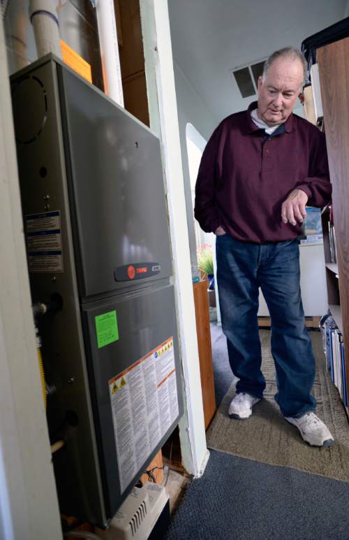 Al Hartmann  |  The Salt Lake Tribune
Doug Fay with the new gas furnace Breathe Utah purchased. He has long heated his Kearns home with a homemade steel plate wood-burning stove. Wood smoke plays a surprisingly large impact on the Wasatch Front's wintertime air quality so the state is encouraging residents to convert wood-burning devices to natural gas..