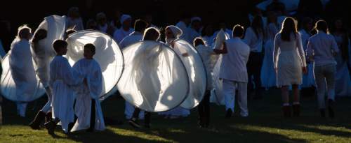 Steve Griffin  |  The Salt Lake Tribune

People dressed all in white and wearing their costumes wait on the sidewalk at Rock Canyon Park as they joined 1039 participants in an attempt to break a world record for a living nativity in Provo, Monday, December 1, 2014.