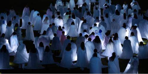 Steve Griffin  |  The Salt Lake Tribune

People dressed all in white and wearing their costumes which are lit by LED lights wait at Rock Canyon Park as they are joined by 1039 participants in an attempt to break a world record for a living nativity in Provo, Monday, December 1, 2014.