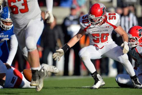 Chris Detrick  |  The Salt Lake Tribune
American Fork's Riley Phillips (50) looks to recover a bad snap during the 5A state championship game at Rice-Eccles Stadium Friday November 21, 2014.