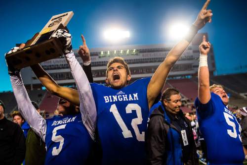 Chris Detrick  |  The Salt Lake Tribune
Bingham's Colton Livingston (5) Chayden Johnston (12) and Charlie Baggett IV (55) celebrate after winning the 5A state championship game at Rice-Eccles Stadium Friday November 21, 2014. Bingham defeated American Fork 20-3.