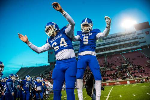 Chris Detrick  |  The Salt Lake Tribune
Bingham's Max Paulson (64) and Bingham's Harley Yazzie (9) celebrate  after winning the 5A state championship game at Rice-Eccles Stadium Friday November 21, 2014. Bingham defeated American Fork 20-3.