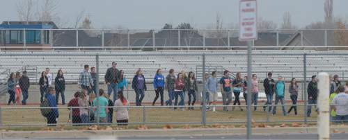 Francisco Kjolseth  |  The Salt Lake Tribune
Students file out of Fremont High school in Plain City during a lock down after reports of a student seen with a gun on Monday, Dec. 1, 2014.