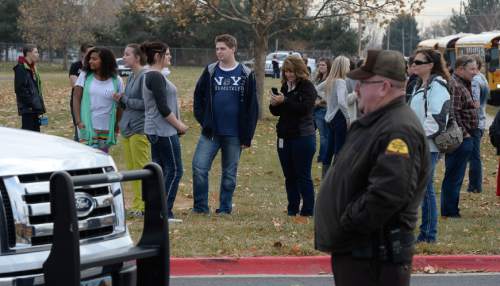 Francisco Kjolseth  |  The Salt Lake Tribune
People gather on the edge of Fremont High school in Plain City during a lock down after reports of a student seen with a gun on Monday, Dec. 1, 2014.
