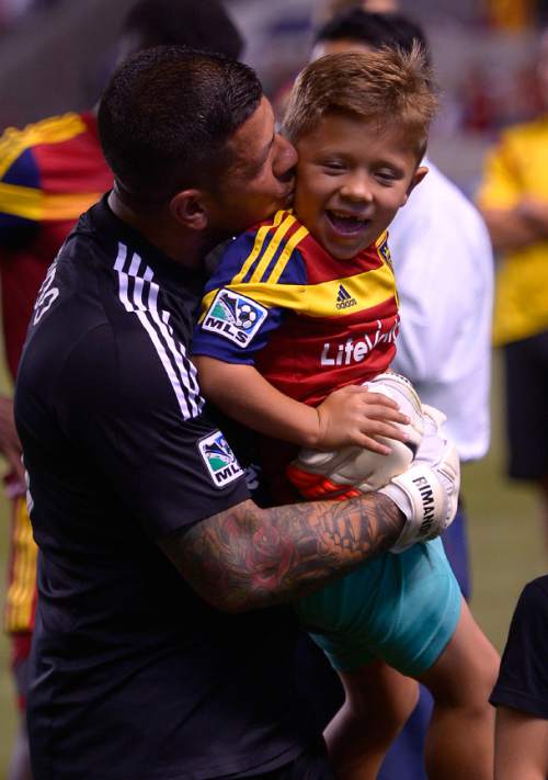 Leah Hogsten  |  The Salt Lake Tribune
Real Salt Lake goalkeeper Nick Rimando (18) celebrates his new MLS record for career game shutouts at 113 with his son Jet. 
Real Salt Lake defeated D. C. United 3-0 Saturday, August 9, 2014, at Rio Tinto Stadium.