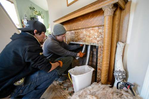 Trent Nelson  |  The Salt Lake Tribune
Ben Loya and Tyler Marquardt install a gas fireplace at a home in Salt Lake City, Tuesday November 11, 2014. Gov. Gary Herbert has proposed banning the use of all wood-burning devices to help improve air quality.