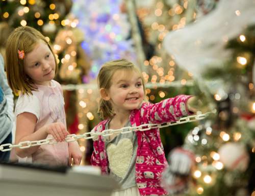 Rick Egan  |  The Salt Lake Tribune

Sophie Olsen, 7 (let) and Charlotte Irion, 4, Soiuth Jordan, check out the exhibits at the Festival of Trees at the South Towne Expo Center, Thursday, December 4, 2014. The Festival continues from 10 am to 10 pm until December 6.