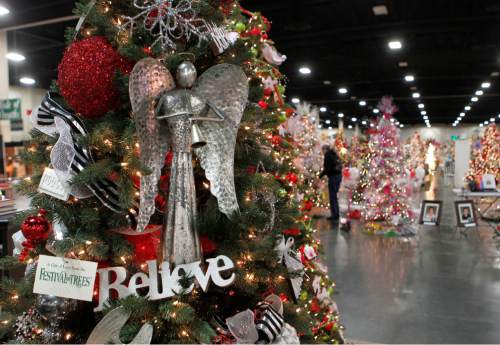 Al Hartmann  |  Tribune file photo
A volunteer with the 2012 Festival of Trees makes last minute touches to displays in the annual fundraiser for Primary Children's Hospital. This year's festival runs through Saturday at the South Towne Expo Center in Sandy.