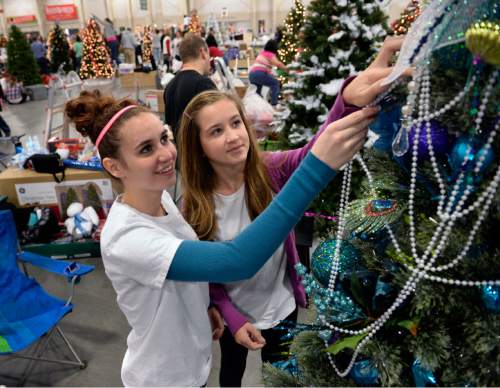Al Hartmann  |  The Salt Lake Tribune
Aubrey Slack, 19, left, and Emma Heidelberger, 12, who both suffer from postural orthostatic tachycardia syndrome, or POTS, a debilitating but fairly unknown disease, finish decorating a tree at the Festival of Trees Monday December 2 . It's to raise awareness of POTS and raise money for Primary Children's Medical Center.  Their tree's theme is "Breakfast at Tiffany's."  The two girls met this fall and now are each other's support. Aubrey was diagnosed four years ago, but Emma was just diagnosed in early October.