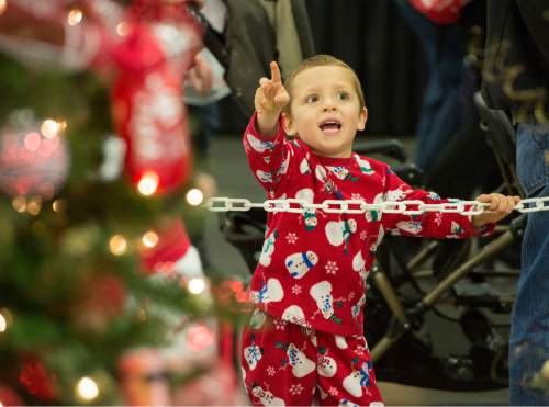 Rick Egan  |  The Salt Lake Tribune

Wyatt Milar, 4, South Jordan, points out a tree to his family, at the Festival of Trees at the South Towne Expo Center, Thursday, December 4, 2014. The Festival continues from 10 am to 10 pm until December 6.