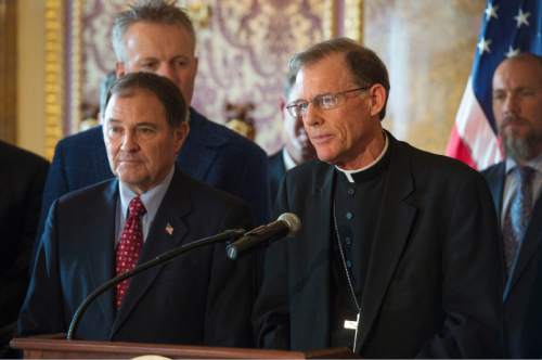 Steve Griffin  |  The Salt Lake Tribune

The Most Reverend John Wester Bishop of Salt Lake City, joins Gov. Gary Herbert as the governor addresses the media as he releases his detailed Healthy Utah plan, which is an alternative way to expanding health care coverage for the poor without technically expanding Medicaid. The plan was hammered out in months of negotiation this year with the U.S. Department of Health and Human Services. He was joined in the Gold Room at the Utah State Capitol by city and state leaders in Salt Lake City, Thursday, December 4, 2014.