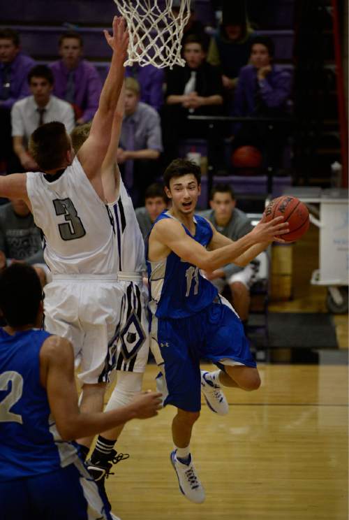 Scott Sommerdorf   |  The Salt Lake Tribune
Bingham's Landon Walbeck leaps under the hoop trying to pass to Yoeli Libii during first half play. The Miners held a 30-14 lead at the half over Riverton at Riverton High, Friday, December 5, 2014.