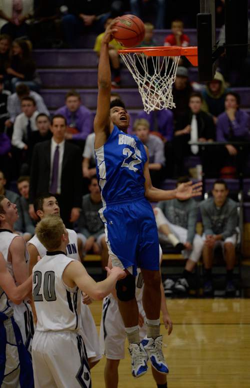 Scott Sommerdorf   |  The Salt Lake Tribune
Bingham's Yoeli Libii goes above the rim to make one of two first half dunks over the Riverton defense.  The Miners held a 30-14 lead at the half over Riverton at Riverton High, Friday, December 5, 2014.