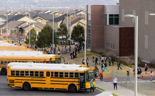 Trent Nelson  |  The Salt Lake Tribune
Students load into buses after a day of classes at Sunset Ridge Middle School in West Jordan, Friday December 5, 2014. The City of West Jordan, City of South Jordan and Herriman City held a joint press conference to discuss their opposition to a  proposed relocation of the state prison to West Jordan. The proposed location is 9000 South and 7300 West.
