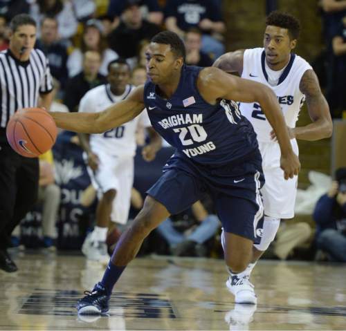 Steve Griffin  |  The Salt Lake Tribune

Brigham Young Cougars guard Anson Winder (20) scoops up a loose ball during first half action in the BYU versus USU men's basketball game in Logan, Tuesday, December 2, 2014.