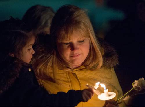 Rick Egan  |  The Salt Lake Tribune

Brittany Bezanson holds her daughter Arley, 4, South Jordan, as she lights her candle during the annual ceremony for grieving parents at the Christmas Box Angel, at the Salt Lake City Cemetery, Saturday, December 6, 2014