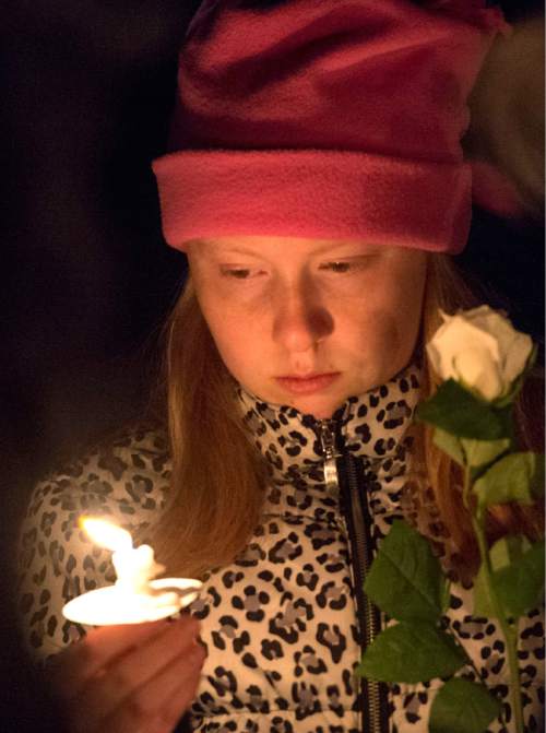 Rick Egan  |  The Salt Lake Tribune

Grace Adams, 13, South Jordan, holds a a candle during the annual ceremony for grieving parents at the Christmas Box Angel, at the Salt Lake City Cemetery, Saturday, December 6, 2014