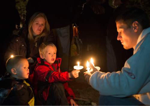 Rick Egan  |  The Salt Lake Tribune

Heath and Casey Maarse light candles for  their children, Ryker, 2, and Leland, 5 during the annual ceremony for grieving parents at the Christmas Box Angel, at the Salt Lake City Cemetery, Saturday, December 6, 2014