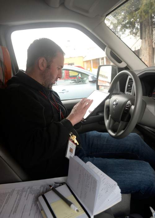 Al Hartmann  |  The Salt Lake Tribune
Phil Taylor, nurse practitioner for the Fourth Street Clinic makes notes and checks medical records on a wi-fi tablet in the clinics mobile medical van.
