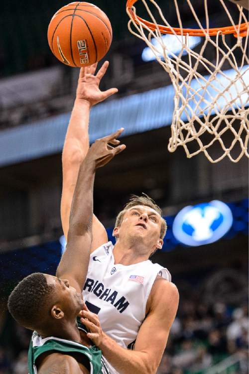 Trent Nelson  |  The Salt Lake Tribune
Brigham Young Cougars guard Kyle Collinsworth (5) shoots the ball over Hawaii Warriors forward Mike Thomas (25) as BYU faces Hawaii, college basketball at EnergySolutions Arena in Salt Lake City, Saturday December 6, 2014.
