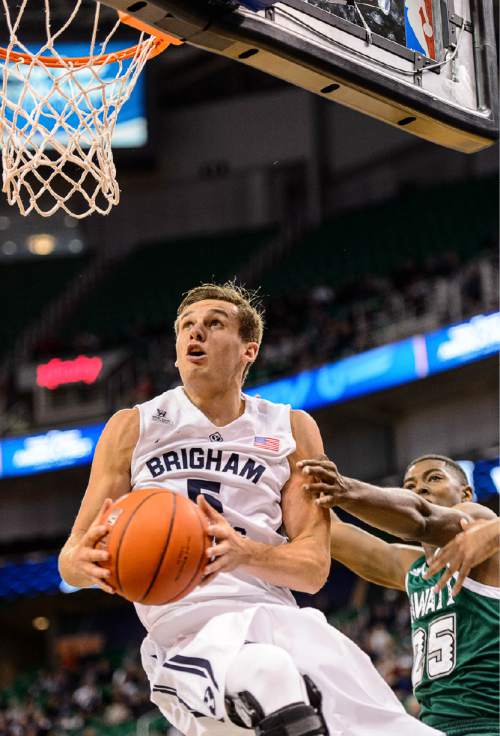 Trent Nelson  |  The Salt Lake Tribune
Brigham Young Cougars guard Kyle Collinsworth (5) flies across the baseline as BYU faces Hawaii, college basketball at EnergySolutions Arena in Salt Lake City, Saturday December 6, 2014. At right is Hawaii Warriors forward Mike Thomas (25).