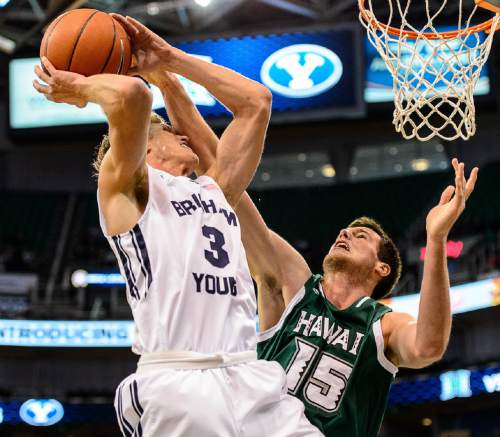 Trent Nelson  |  The Salt Lake Tribune
Brigham Young Cougars guard Tyler Haws (3) is fouled by Hawaii Warriors center Stefan Jovanovic (15) as BYU faces Hawaii, college basketball at EnergySolutions Arena in Salt Lake City, Saturday December 6, 2014.