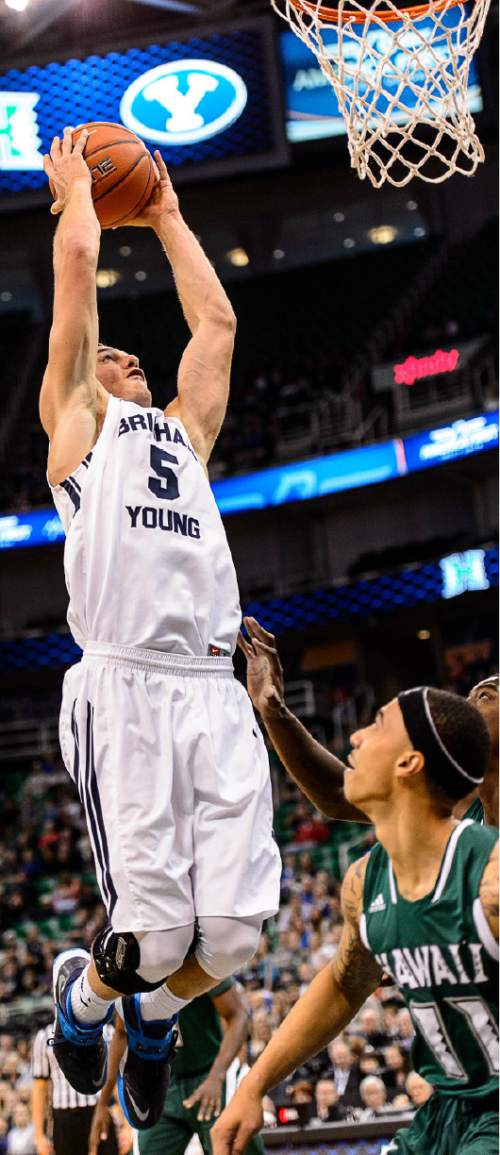 Trent Nelson  |  The Salt Lake Tribune
Brigham Young Cougars guard Kyle Collinsworth (5) goes up for a dunk over Hawaii Warriors guard Quincy Smith (11), as BYU faces Hawaii, college basketball at EnergySolutions Arena in Salt Lake City, Saturday December 6, 2014.