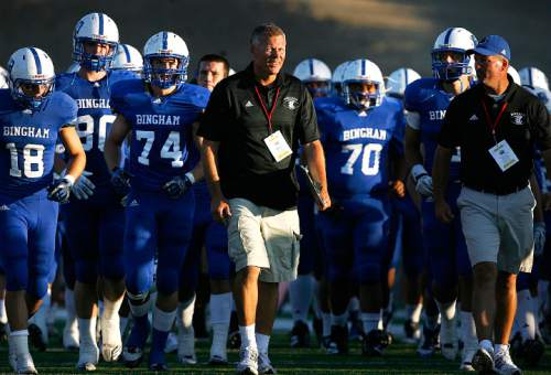 Scott Sommerdorf  |  The Salt Lake Tribune             
Bingham coach Dave Peck, right, and incoming Miners coach John Lambourne, left, leads his team off the field at halftime trailing 21-7. Bingham High plays Orange Lutheran in Mission Viejo, Saturday, September 3, 2011.