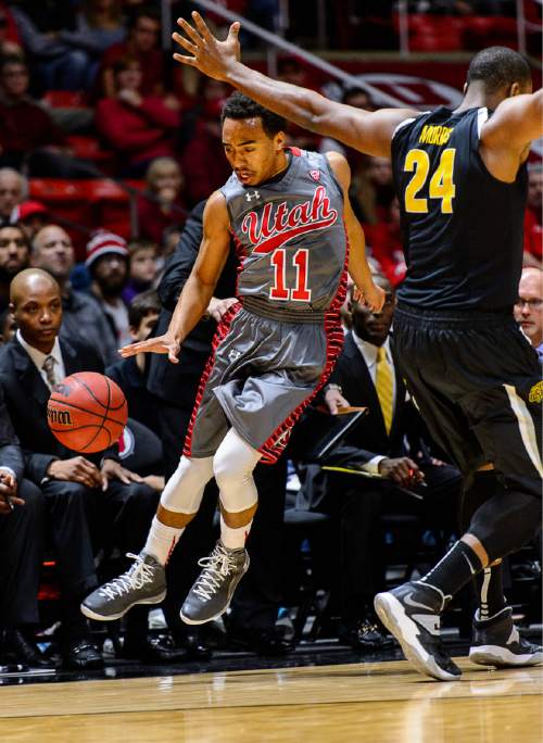Trent Nelson  |  The Salt Lake Tribune
Utah Utes guard Brandon Taylor (11) tries to stay in bounds, going around Wichita State Shockers forward Shaquille Morris (24) as the University of Utah Utes host the Wichita State Shockers, college basketball at the Huntsman Center in Salt Lake City, Wednesday December 3, 2014.
