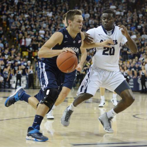 Steve Griffin  |  The Salt Lake Tribune

Brigham Young Cougars guard Kyle Collinsworth (5) drives on Utah State Aggies guard Henry Bolton (20) during first half action in the BYU versus USU men's basketball game in Logan, Tuesday, December 2, 2014.