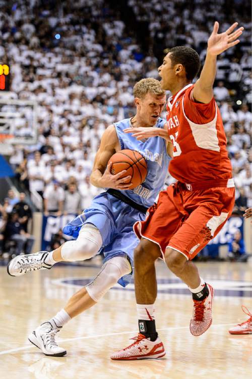 Trent Nelson  |  The Salt Lake Tribune
Brigham Young Cougars guard Tyler Haws (3) defended by Utah Utes guard Kenneth Ogbe (25) as BYU hosts Utah, college basketball at the Marriott Center in Provo, Wednesday December 10, 2014.
