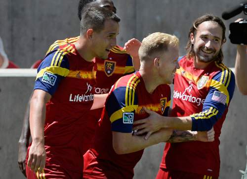 Scott Sommerdorf   |  The Salt Lake Tribune
RSL midfielder Ned Grabavoy celebrates with Luke Mulholland, second from right, who is mobbed by team mates after Mulholland's shot gave RSL a 2-0 lead early in the second half. RSL defeated the Seattle Sounders 2-1 at Rio Tinto Stadium, Saturday, August 15, 2014.
