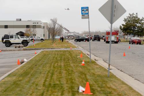 Trent Nelson  |  The Salt Lake Tribune
Cones mark large pieces of debris on the ground nearly a block away from the scene of a helicopter crash at 500 West 900 North in North Salt Lake, Tuesday December 2, 2014.